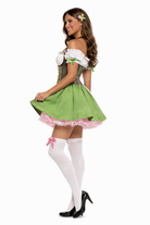 Woman wearing a green and white beer girl costume with a white background