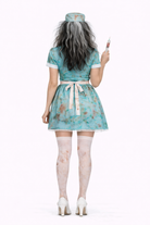 Person wearing a teal dress with floral patterns, holding a syringe on a white background