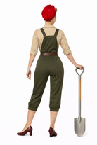 Person wearing green overalls holding a shovel on a white background