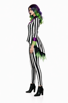 Person wearing a black and white striped costume with green accents on a white background