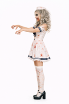 Person wearing a zombie nurse costume on a white background